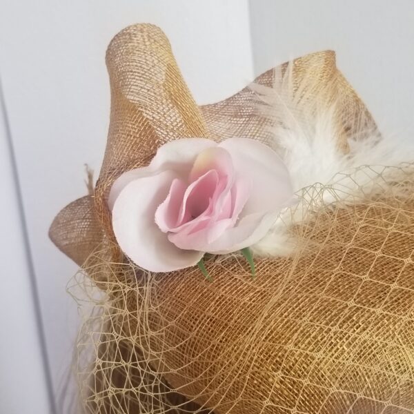 close of sinamay rose and feather decoration