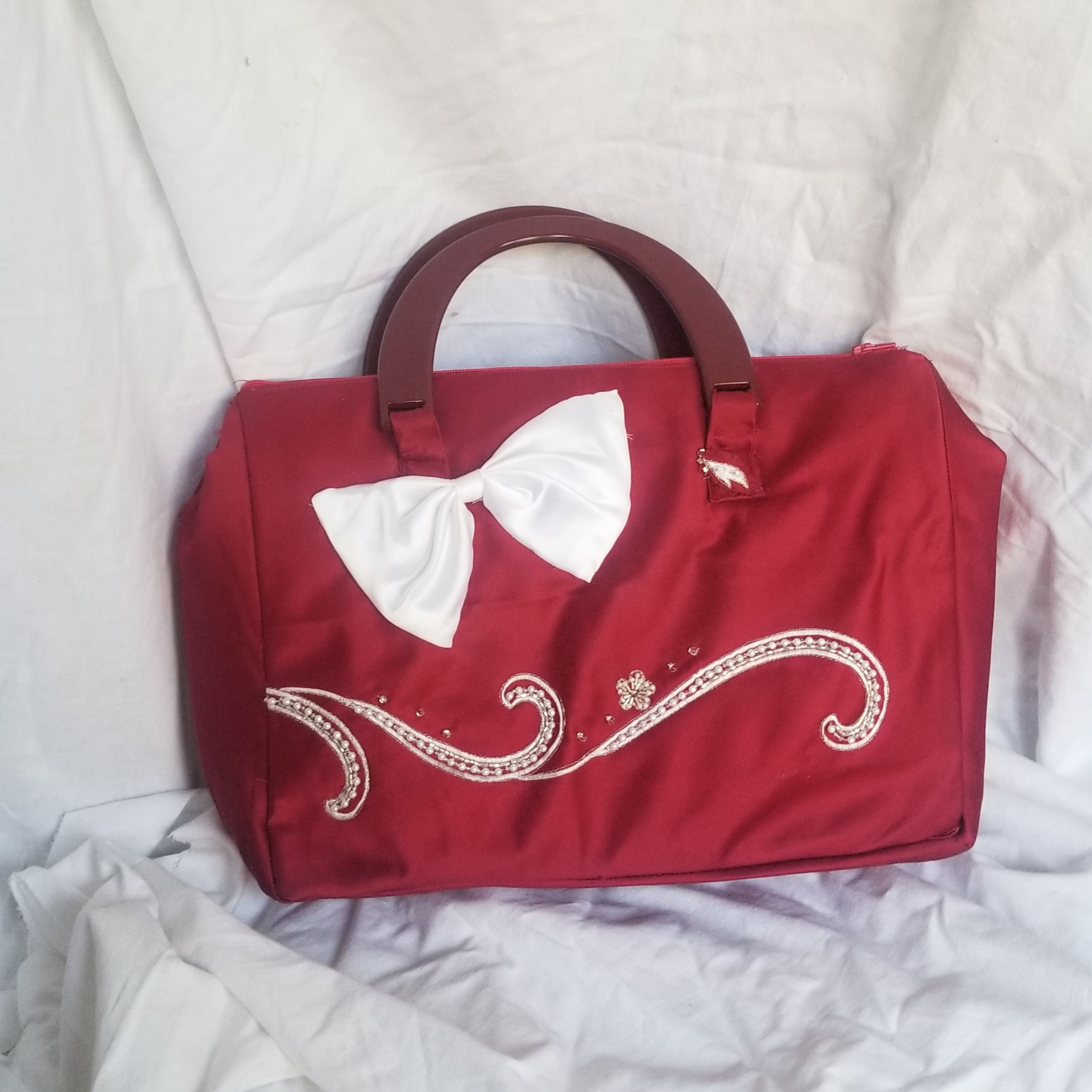 large red bag with white bow