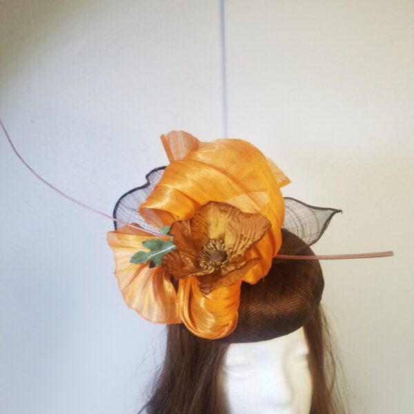 brown button hat with orange trim and feather