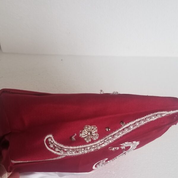 red clutch bag with white bow side image
