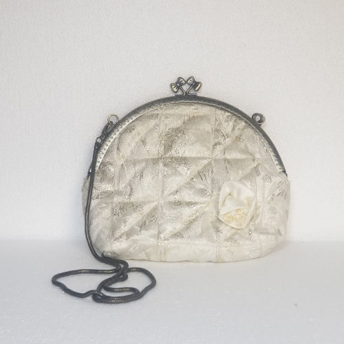 white and gold clutch bag
