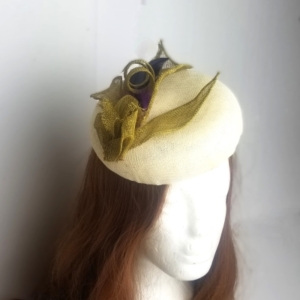 cream sinamay hat with gold sinamay and feather decoration