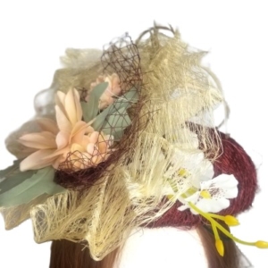 aubergine tangletuft flower and feather hat